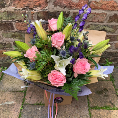 Petal Paradise - A lively bouquet featuring a bright mix of vibrant seasonal blooms. Complemented by lush green foliage and presented in a beautiful packaging, this arrangement is perfect for adding a pop of colour to any occasion