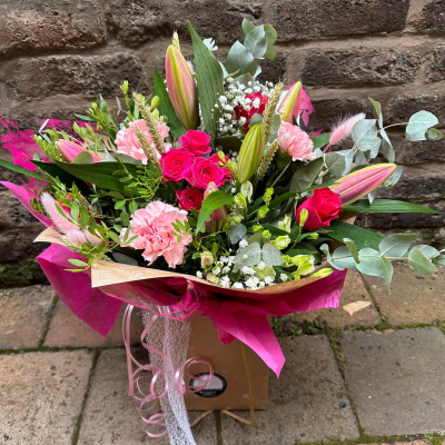 Blushing Meadow - A stunning collection of pink and green seasonal flowers in toning packaging. This bouquet is designed to impress and uplift any space.