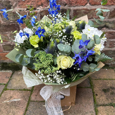 Oceanic Bliss - Revel in the elegance of this luxurious bouquet, featuring a captivating mix of white and blue blooms. Presented in beautiful packaging, it’s perfect for making a sophisticated statement.