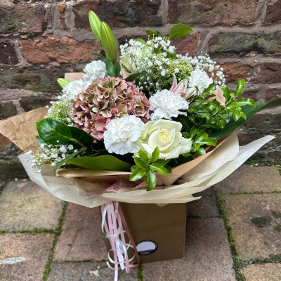 Evelyn - A fabulous collection of white and cream flowers make this the perfect gift. This bouquet will be hand delivered by the local florist.