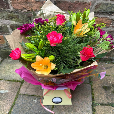 Hidden Treasure - An outstanding hand tied bouquet with a cascade of colour and a treasure chest overflowing with the beautiful flowers.