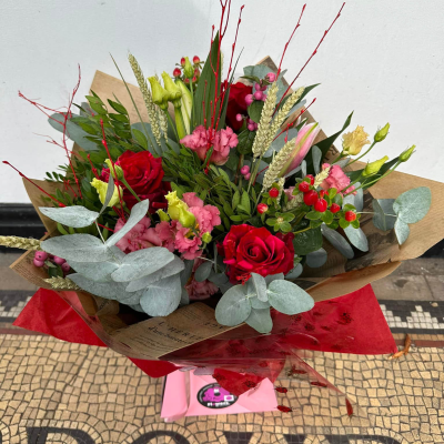 Smooch - 6 red roses and 6 red carnations with choice filler and foliage in a hand-tied or arrangement  in Oasis and presented in a gift bag or box.