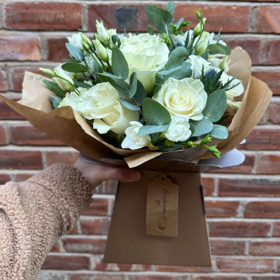 Classic Harmony - Share your sentiments with this beautiful arrangement of white and green blooms complemented by lush greenery. Presented in elegant wrapping.